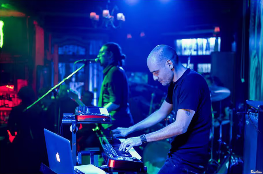 Rear view of Petros and Alex of Come with Reverse performing on stage at Ghost House, focusing on their engagement with the music.